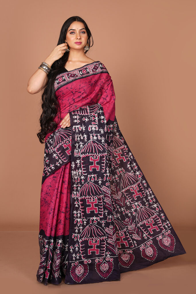 Batik Print Saree featuring traditional tribal/Warli folk art motifs and geometric borders.